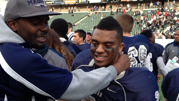 San Diego Madison running back Pierre Cormier gets congratulations after team won CIF Division III state title last December. The Warhawks are 36-4-1 over the current decade.