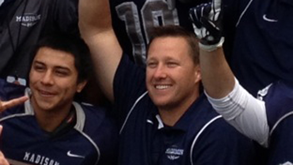 Coach Rick Jackson of San Diego Madison poses with team after CIF Division III bowl victory.