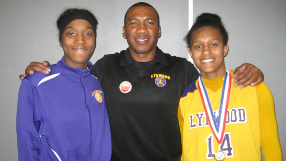 Veteran head coach Ellis Barfield of Lynwood is flanked by seniors Amber Blockmon and Alize Lofton after the Knights won the 2013 CIF Southern California Division II title last Saturday. Photo: Ronnie Flores.