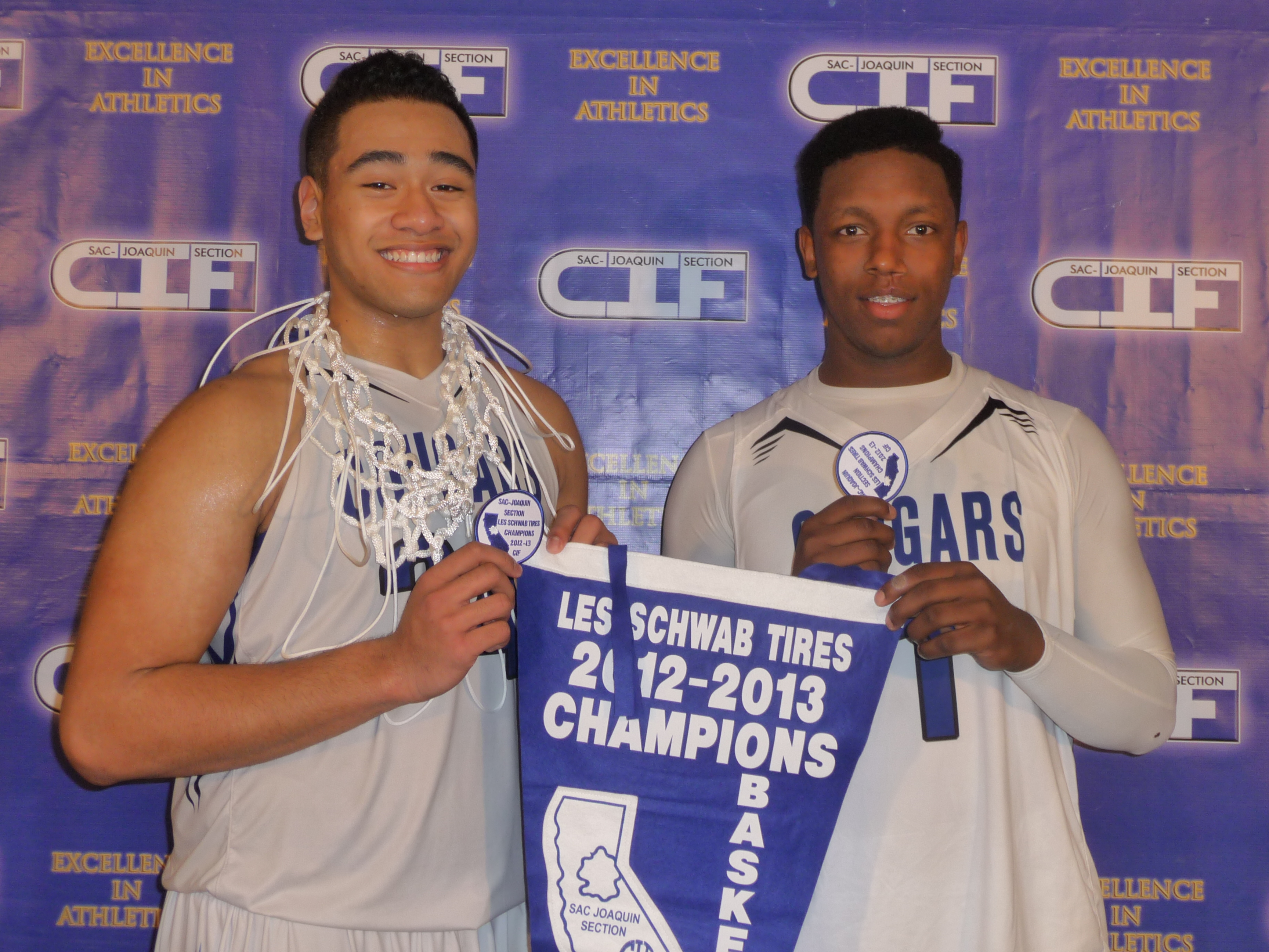 Nifae Lealao and Trey Belton (both grid-hoopers) show off some of the championship gear they and their team at Capital Christian of Sacramento collected after the CIF Sac-Joaquin Section Division V championship.
