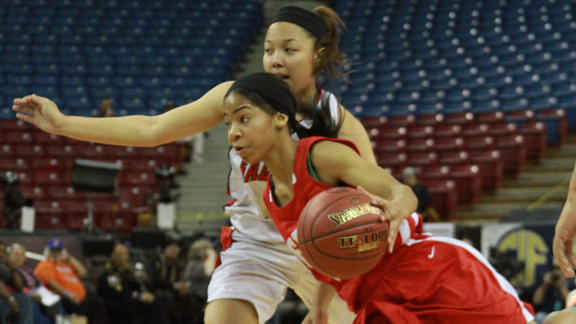 Gardena Serra's Deandrea Toler drives around Richmond Salesian's Taylor Crowder during Saturday's CIF Division IV girls state final. Toler had 20 points in Serra's victory. Photo: Willie Eashman.