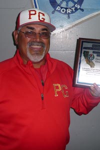 Gil Ruiz holds CCS D3 championship coaches' plaque.