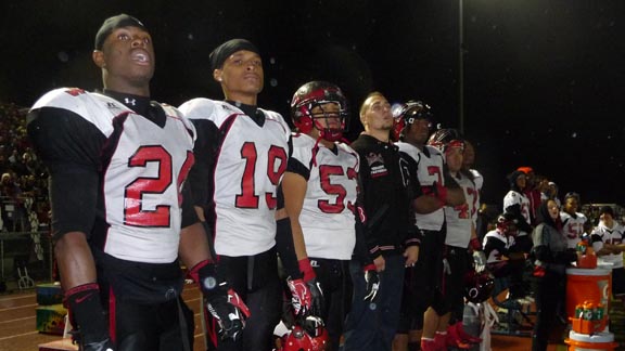 Players at Corona Centennial stand on the bench to peak at the action during the 2012 CIF Southern Section Inland Division championship. Photo: Mark Tennis.