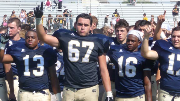 Isaias Majera (67) is among the Notre Dame of Sherman Oaks players who are saluting their band after win during Saturday's games in Oceanside. Photo: Mark Tennis.