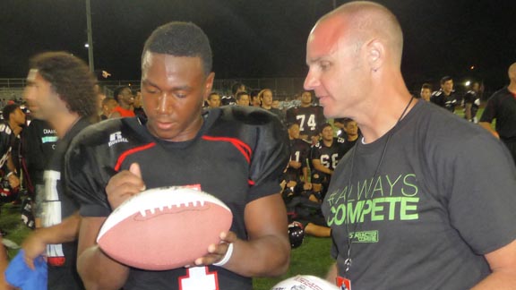 Corona Centennial running back Tre' Watson signs a ball for UT San Diego Honor Bowl official. Watson and team were involved in several zany games in 2013. Photo: Ronnie Flores.