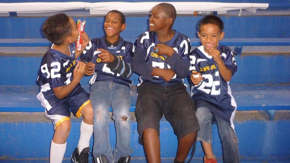 Four youngsters at Friday's game between Grant of Sacramento and Oak Ridge of El Dorado Hills are either excited the game is about to start or they're excited about eating candy.