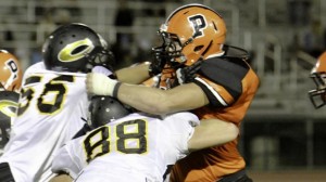 Two blockers attempt to slow down Santa Ynez DE Clayton Hanly from earlier this season. Hanly had 8.5 sacks in one game. Photo: Hal Curry Photography (via school).