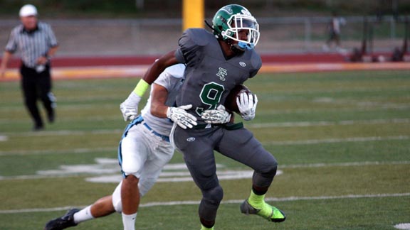 El Cerrito's Keith Benjamin is about to get tackled during game earlier this season against Bellarmine. Those teams are now ranked closer together this week. Photo: Phlllip Walton/SportStars.