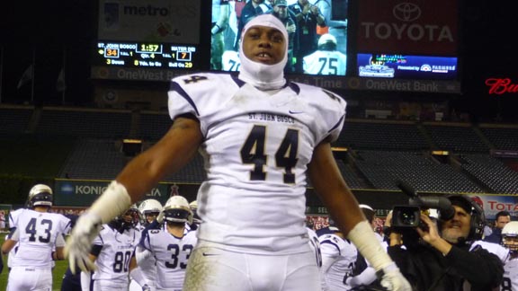 St. John Bosco defensive end Malik Dorton stands on the team's bench and looks toward the crowd during the final minute of CIFSS final at Angels Stadium. Photo: Mark Tennis.