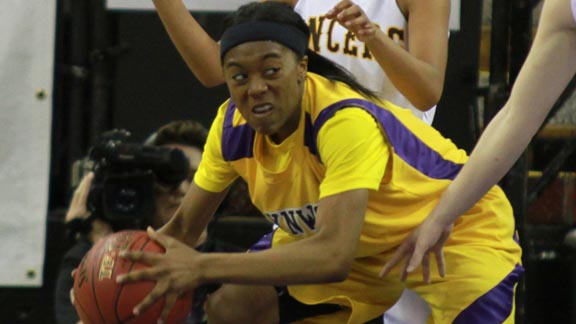 Jazmine Johnson of Lynwood battles a double-team from the defense of Mountain View St. Francis in last year's CIF Division II state final. Lynwood won 39-26. Photo: Willie Eashman.