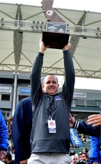 Corona del Mar head coach Scott Meyer hoists CIF Division III state title trophy after win last month over Sacred Heart Prep. Photo: Scott Kurtz.