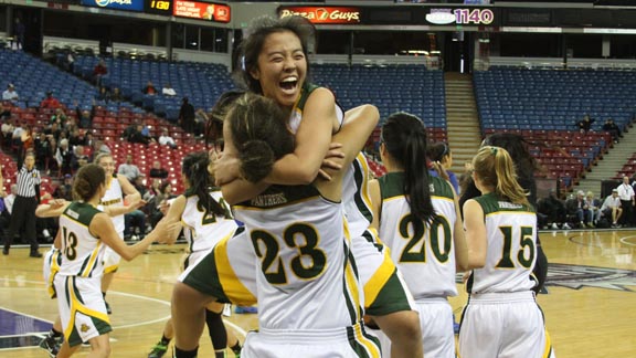 Junior point guard Marissa Hing leaps into the arms of Pinewood teammate Chloe Eackles after team won CIF Division V state title with win over La Jolla Country Day. Photo: Willie Eashman.