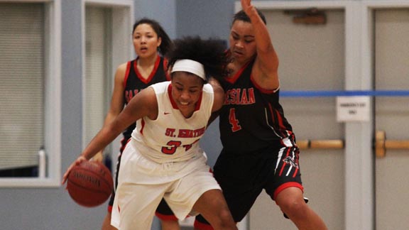 Senior Quinci Mann from St. Ignatius of San Francisco gets hounded by tough defense of Richmond Salesian's Mariya Moore during Friday night's CIF NorCal Open Division game in San Francisco won by Salesian. Photo: Willie Eashman.