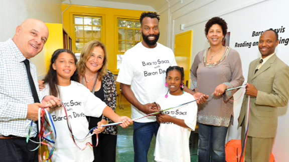 Former NBA All-Star, UCLA and Crossroads of Santa Monica standout Baron Davis (center) cuts ribbon at cemeromy for unveiling of Reading & Learning Center at his old elementary school in South Los Angeles. Also pictured (L to R): Davis' 5th grade teacher Mr. Deebs, South Park Elementary student Selina, CEO of LA's BEST Carla Sanger, Davis' cousin and South Park student Essence, basketball great Cheryl Miller and South Park Elementary Principal Mr. Schaffer.