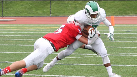 Dominic Burke, a 6-1, 205-pound linebacker from unbeaten St. Ignatius, makes tackle against Tavonne Johnson from Stockton St. Mary's during game last Saturday in San Francisco. Photo: Willie Eashman.