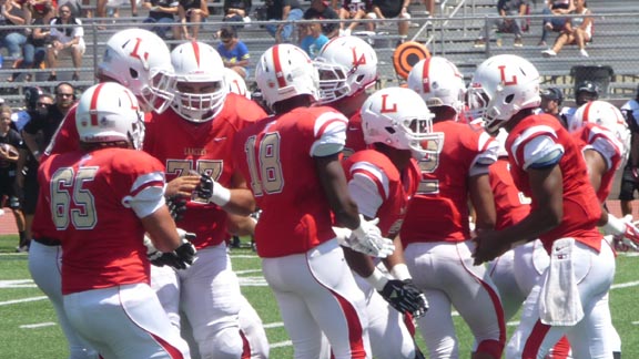 The Orange Lutheran offense breaks its huddle during 52-49 loss to Corona Centennial. The only other loss by a Trinity League team this season was Servite of Anaheim falling to nationally ranked Bishop Gorman. Photo: Mark Tennis.