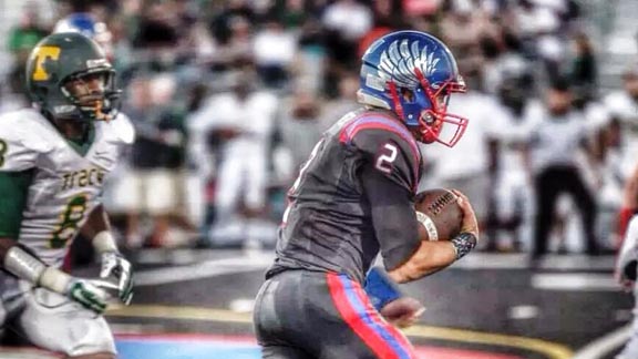 Clayton Valley of Concord QB Ryan Cooper heads downfield during team's Week 2 win over Tracy on black home field. Photo: Dax Crabbe.