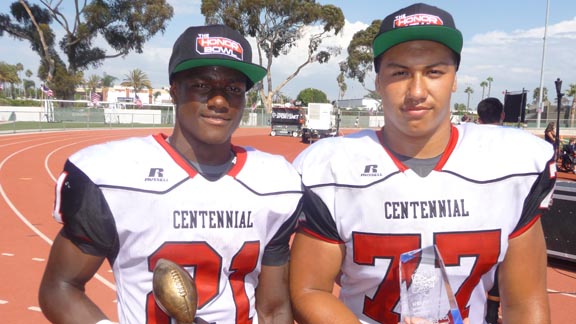 Collecting hardward for Centennial after its win over Orange Lutheran were running back J.J. Taylor (MVP) and offensive lineman Sid Acosta (Character Counts). Photo: Mark Tennis.