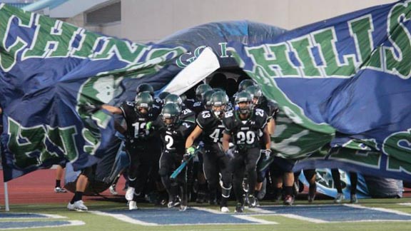 Chino Hills players break the banner prior to playing and winning their biggest game of the season so far against Bishop Amat of La Puente. Photo: Chino Hills Facebook Page.
