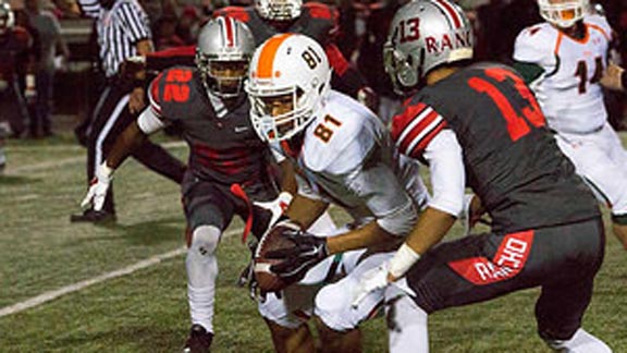 Josh Evans of Riverside Poly makes a grab in front of defenders from Rancho Verde of Moreno Valley during 59-45 win by team last week. Photo: Mark Benoit/polybearsfootball.com.