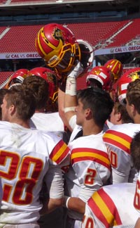 Oakdale players raise their helmets at Levi's Stadium after posting victory over Manteca. Photo: Mark Tennis.