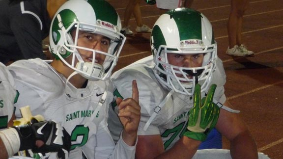 Stockton St. Mary's teammates Noah Righetti and Shane McDermott were in a good mood as their team was comfortably ahead on Friday in a 46-14 win over previously unbeaten West of Tracy. Righetti ran for three TDs and passed for two others. Photo: Mark Tennis.