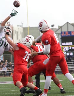 St. Ignatius QB Ryan Hagfeldt tries to get a pass off during annual rivalry game played on Saturday against Sacred Heart Cathedral. Photo: Willie Eashman.