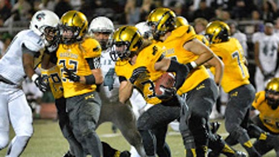 El Capitan's D.J. Smith runs behind a wall when team beat Helix. Vaqueros likely to host D3 South bowl game next week. Photo: EastCountySports.com.