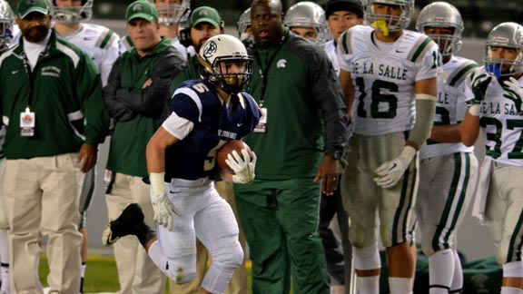 St. John Bosco's Sean McGrew flies down the sidelines in front of the Concord De La Salle bench in last December's CIF Open Division state final. Head coach Justin Alumbaugh is directly behind McGrew's left shoulder. Photo: Scott Kurtz.