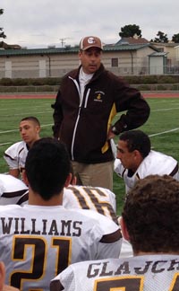 St. Francis head coach Greg Calcagno talks to the players after win last Friday in Daly City. Photo: Harold Abend.