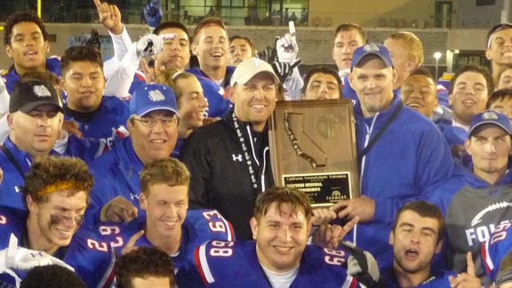 Folsom co-coaches Troy Taylor (left) and Kris Richardson hold CIF NorCal D1 title plaque with players after their team beat Grant of Sacramento on Friday. Photo: Mark Tennis.