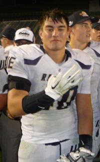 Kekupaa Freehauf, a junior linebacker, signals three for the third straight CIF state title for Modesto Central Catholic. Photo: Mark Tennis.