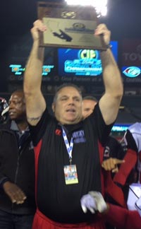 Corona Centennial head coach Matt Logan raises CIFSS Pac-5 title plaque last December. Photo: Mark Tennis.