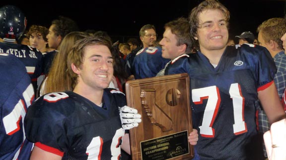 Campolindo players Conner McNally (who scored the team's last TD) and Ryan Geistreiter pose with NorCal title trophy after 35-14 win against Sutter. Photo: Mark Tennis.