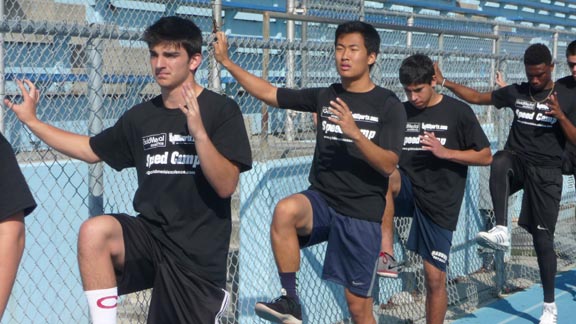 Athletes practice their form, getting ready to "sweep the ground" during a drill they are learning at the first Cal-Hi Sports/Gold Medal Excellence Speed Camp. Photo: Mark Tennis.