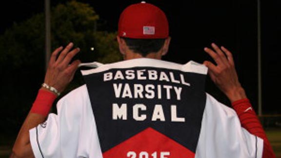 Redwood of Larkspur player holds league title banner. The Giants, by virtue of owning a win over Cardinal Newman of Santa Rosa and with that team winning its league title last week as well, earned No. 1 seed for NCS D2 playoffs. Photo: redwoodbaseball.com.