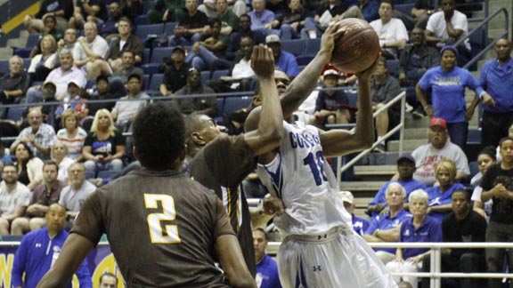 All-State Division IV player Justice Shelton-Mosley of Sacramento Capital Christian goes up for shot against fellow all-stater De'Anthony Melton of Crespi. Photo: Willie Eashman.