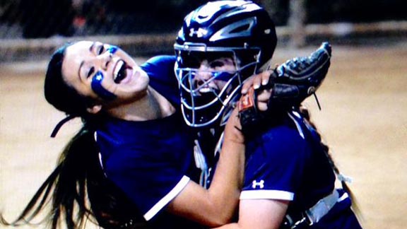 Yucaipa pitcher Brooke Bolinger and catcher Kelly Martinez embrace after final out in biggest win in school history in any sport. Photo: Patrick Takkinen/OCSidelines.com. 