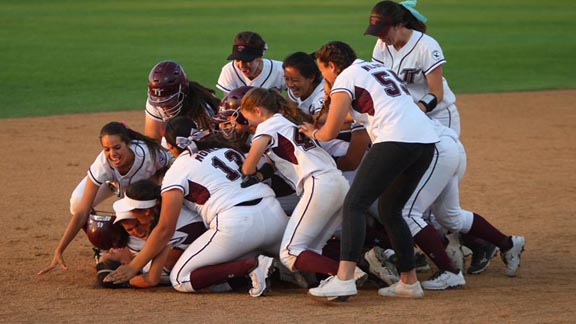 Torrance players mob each other after winning run scores in CIF Southern Section Division III championship. Photo: Patrick Takkinen/OCSidelines.com.