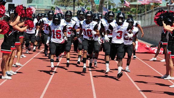 It's always a train of more than 100 when the Corona Centennial team runs through its throng of cheerleaders. Great group of returnees. Photo: centennialhuskyfootball.com.