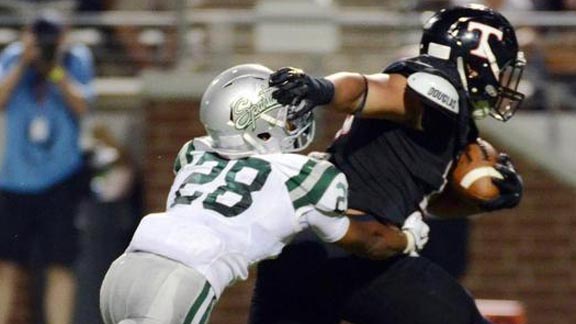 Trinity QB Tyler Natee looks to escape the grasp of De La Salle's Antoine Custer during last Saturday's game in Mansfield, Texas. Photo: TrinityTrojanFootball.com.