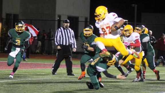 Running back Emilio Martinez from last year's team at Palma of Salinas leaps over a defender from Monterey. Photo: Kalia Stornetta/Prep2Prep.com.