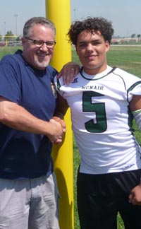 Cal-Hi Sports editor Mark Tennis shakes hands with Bear Tennis, junior linebacker from McNair of Stockton. Photo: Seth Tennis.