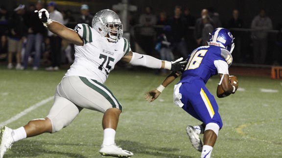 Boss Tagaloa of Concord De La Salle reaches out to try to grab San Mateo Serra QB Leki Nunn during last Friday's game at Serra. Photo: Willie Eashman.