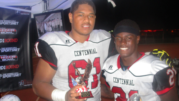 Corona Centennial offensive lineman Paula Hafoka (left) and star back J.J. Taylor are all smiles after the Huskies' dominant win over Gardena Serra at the 2015 Honor Bowl at Oceanside High School. Photo: Ronnie Flores.