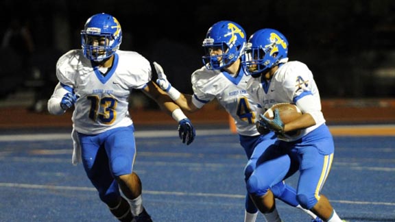 Players from Bishop Amat of La Puente charge up the blue field in recent game vs. Chaminade of West Hills. Photo: AmatTDClub.com.