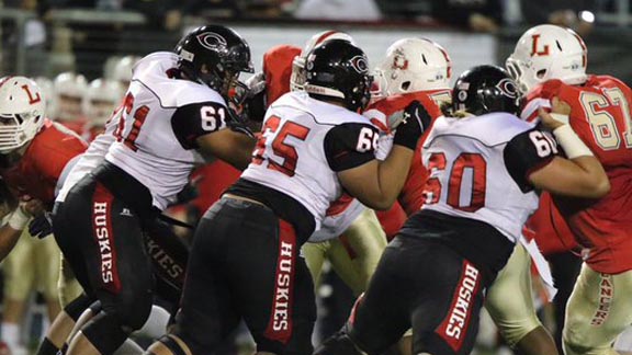 Doing some blocking for No. 2 Centennial in its win on Friday vs. Lutheran of Orange are Paula Hafoka, Tyler Wells and Ian Lauvai. Photo: Patrick Takkinen/OCSidelines.com.