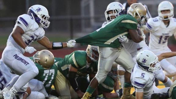 RB Jullen Ison from Moreau Catholic of Hayward gets grabbed during game earlier this season vs. Piedmont. Photo: Willie Watson/piedmontfootball.com.