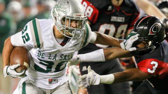 De La Salle's Andrew Hernandez delivers stiff-arm to fend off Centennial tackler in last year's Open Division contest won by the Spartans 63-42. Photo: Josh Barber/OCSidelines.com.