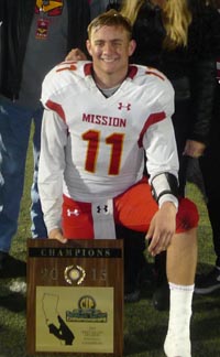 Mission Viejo QB Brock Johnson holds CIFSS title plaque. His father, Bret, had the same experience for El Toro. 